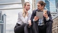 Caucasian business couple sitting together and having business discussion outdoor Royalty Free Stock Photo