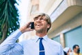 Caucasian business man wearing suit and tie smiling happy outdoors speaking on the phone Royalty Free Stock Photo