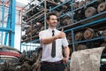 Caucasian business manager stand, smile, holding a tablet, and give thumbs up to his employee who works well in factory-warehouse