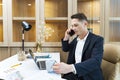 Caucasian business manager using phone to call customer while analyzing the sales report from marketing team for business income Royalty Free Stock Photo