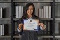 Caucasian business woman posing with certificate of appreciation recieved from business performace competition