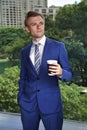 Caucasian businessman with coffee thinking