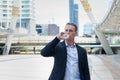 Caucasian businessman drinking pure mineral water from plastic bottle in the city Royalty Free Stock Photo