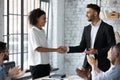 Caucasian businessman handshake greeting biracial female employee Royalty Free Stock Photo