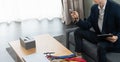 caucasian businessman working with mobile phone and tablet, wear suit, sitting with ties, note and computer on desk. Young man Royalty Free Stock Photo