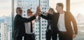 Caucasian businesspeople having high five together to show team unity