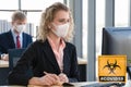 Caucasian businesspeople with medical mask for coronavirus covid 19 protection working in office with covid 19 sign