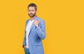 caucasian businessperson in jacket show thumb up isolated on yellow background. Royalty Free Stock Photo