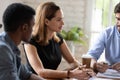 Caucasian businesswoman ceo giving instructions to diverse team at meeting