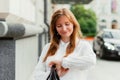 Caucasian businesswoman girl happily smiles and looks at watch