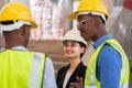 caucasian businesswoman with helmet in black suit happy working with black engineer colleague.