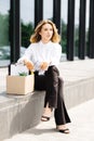 Caucasian businesswoman walking outdoors with box of stuff leaving business. Female office worker lost her job. Fired woman coming Royalty Free Stock Photo