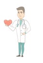 Caucasian cardiologist holding a big red heart.