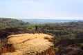 Caucasian Caucasian traveler in sportswear jumping from the happiness of freedom on a rock on the background of nature