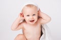 Caucasian, cheerful child looking at the camera. Smiling boy with a towel on his head. After bathing. White background. Royalty Free Stock Photo