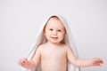 Caucasian, cheerful child looking at the camera. Smiling boy with a towel on his head. After bathing. White background. Royalty Free Stock Photo