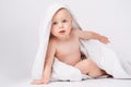 Caucasian, cheerful child looking at the camera. Smiling boy with a towel on his head. After bathing. White background. Royalty Free Stock Photo