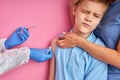 Caucasian child boy is afraid of syringe, he came with mom in hospital Royalty Free Stock Photo