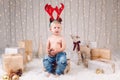 Caucasian child with deer moose horns headband celebrating Christmas or New Year
