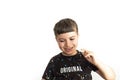 Caucasian child expressing amusement with homework on white background