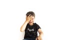 Caucasian child expressing forgetfulness with open hand on forehead on white background