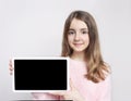 Caucasian child girl holding tablet,empty space blank promotional design image.Kid with screen closeup Royalty Free Stock Photo