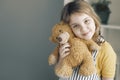 Caucasian child girl hugs teddy bear toy. Little kid happy smiling face portrait empty copy space.Childhood concept Royalty Free Stock Photo