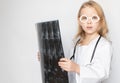 Caucasian child, little doctor looking serious at camera, holding x-ray film Royalty Free Stock Photo