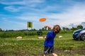 Caucasian child playing disc golf and making the first toss