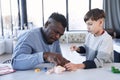 Caucasian child is playing with skeleton with his multiracial father