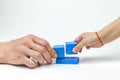 Caucasian child plays with his father in blue wooden cubes