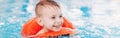 Caucasian child in swimming pool. Preschool boy  training to float with red circle ring in water. Royalty Free Stock Photo