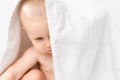 Caucasian child with a towel on his head. White background. Royalty Free Stock Photo