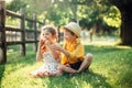 Caucasian children boy and girl siblings sitting together sharing apple