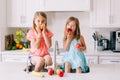 Caucasian Children Girls Eating Fresh Fruits Sitting In Kitchen Sink. Happy Family Sisters Siblings Having Snack. Organic Food And