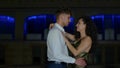 Caucasian classy young man proposing to his girlfriend on a romantic date at night. Happy couple dancing on date then Royalty Free Stock Photo