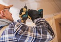 Contractor Assembling Drywall Board Using Drill Driver Royalty Free Stock Photo