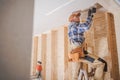 Worker Attaching Drywall