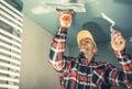 Construction Worker Patching Bathroom Ceiling Royalty Free Stock Photo