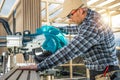 Caucasian Construction Worker Operating Wood Saw