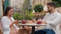 Caucasian couple in city cafe using mobile phone telephone texting working serious man woman breakfast outside together Royalty Free Stock Photo