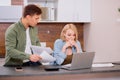 Caucasian couple discussing papers with laptop, man and woman roommates or husband and wife checking rent