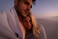 Caucasian couple enjoying time at the beach during the sunset Royalty Free Stock Photo