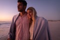 Caucasian couple enjoying time at the beach during the sunset Royalty Free Stock Photo