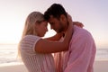 Caucasian couple enjoying time at the beach during the sunset Royalty Free Stock Photo