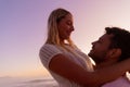 Caucasian couple enjoying time at the beach during the sunset Royalty Free Stock Photo