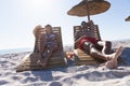 Caucasian couple sitting on deck chairs at the beach Royalty Free Stock Photo