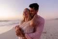 Caucasian couple enjoying time at the beach during the sunset Royalty Free Stock Photo