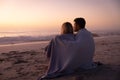 Caucasian couple enjoying time at the beach during the sunset Royalty Free Stock Photo