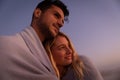 Caucasian couple enjoying time at the beach during the sunset Royalty Free Stock Photo